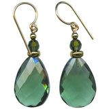 Pair of green teardrop earrings with gold accents on a white background