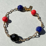 Gold bracelet in natural light on a gray background. Czech glass and Japanese glass accents. Handmade bracelet.