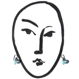 Blue earrings on a black and white illustration of a face.