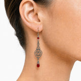 Model wearing red Czech glass earring. 