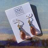 Peach glass earrings with indigo crystal and gold trim.