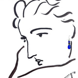A minimalist black line drawing of a woman's face in profile wearing a single dangling blue teardrop earring on a white background.