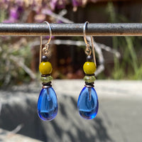 Blue and green glass earrings with bronze trim.