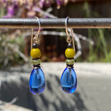 Blue and green glass earrings with bronze trim.