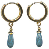 A pair of gold hoop earrings with dangling turquoise-blue teardrop beads on a plain white background.