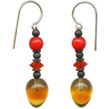 Pair of earrings with red and orange beads on a white background