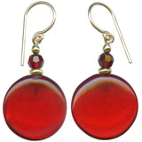 Red glass earrings with crystal and gold accents on a white background.