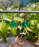 Teal glass earrings with fuschia crystal top beads.