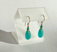 Frosted teal glass earrings with emerald crystal accents