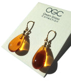 Bright orange dainty drop glass earrings. Gold trim and ear wires. Handmade in the USA using European glass.