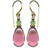 A pair of rose pink German glass drop earrings with gold filled ear wires and green Austrian crystal peridot accents.