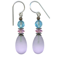 Frosted light amethyst glass drop earrings. Top focal bead is Czech glass in aqua, with pink diamond cut Austrian crystal. Metal trim is antiqued bronze, with sterling silver ear wires. All handwork done in the USA.