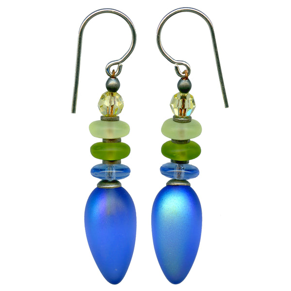 Iridescent sapphire blue frosted drop earrings with Czech glass accents and pale yellow Austrian crystal top bead. Metal trim is antiqued silver overlay with sterling silver ear wires. All handwork done in the USA.