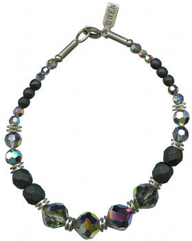 Jet and crystal bracelet. Austrian iridescent crystal focal beads with Czech glass jet beads. Metal trim is antiqued silver overlay, from our own tooling. 7 inches long with a 1 inch extender included. 